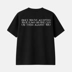 A black short-sleeve t-shirt shown from the back, featuring a large white graphic print with Japanese text and 'ARAKAWA HALF MARATHON' and 'PRESENTED BY BOOST' on the upper back, set against a plain off-white background.