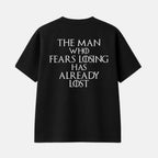 Veltino oversized black 240 GSM cotton terry t-shirt, front view with small white star logo and VELTINO wordmark on the chest