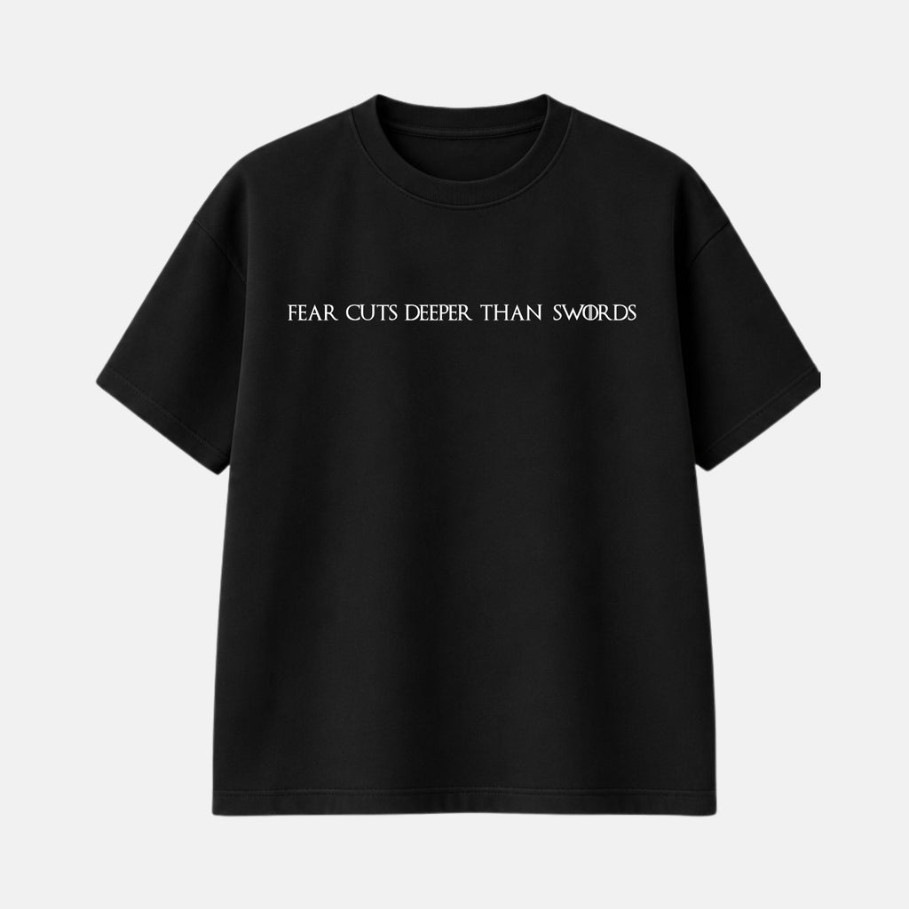 Veltino oversized black 240 GSM cotton terry t-shirt, front view with white text across the chest reading “Fear cuts deeper than swords”