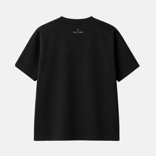 Back view of black Veltino oversized terry cotton t-shirt with small white star logo and Veltino branding at the neck