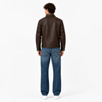 Male model wearing the Veltino unisex brown leather jacket with a white tee