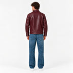 Male model wearing the Veltino unisex burgundy leather jacket with a black tee