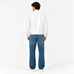 Male model wearing the Veltino unisex white leather jacket with a black tee